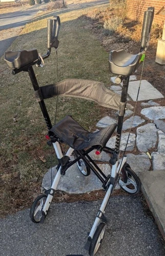 Stand up folding handicap walker with seat & arm rests. Adjustable height