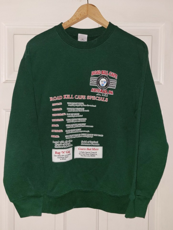 A genuine vintage 'Roadkill Cafe Bar & Grill' sweatshirt with a printed menu of weekly gross-out specials — one of those gloriously regional novelty items that couldn't exist today.