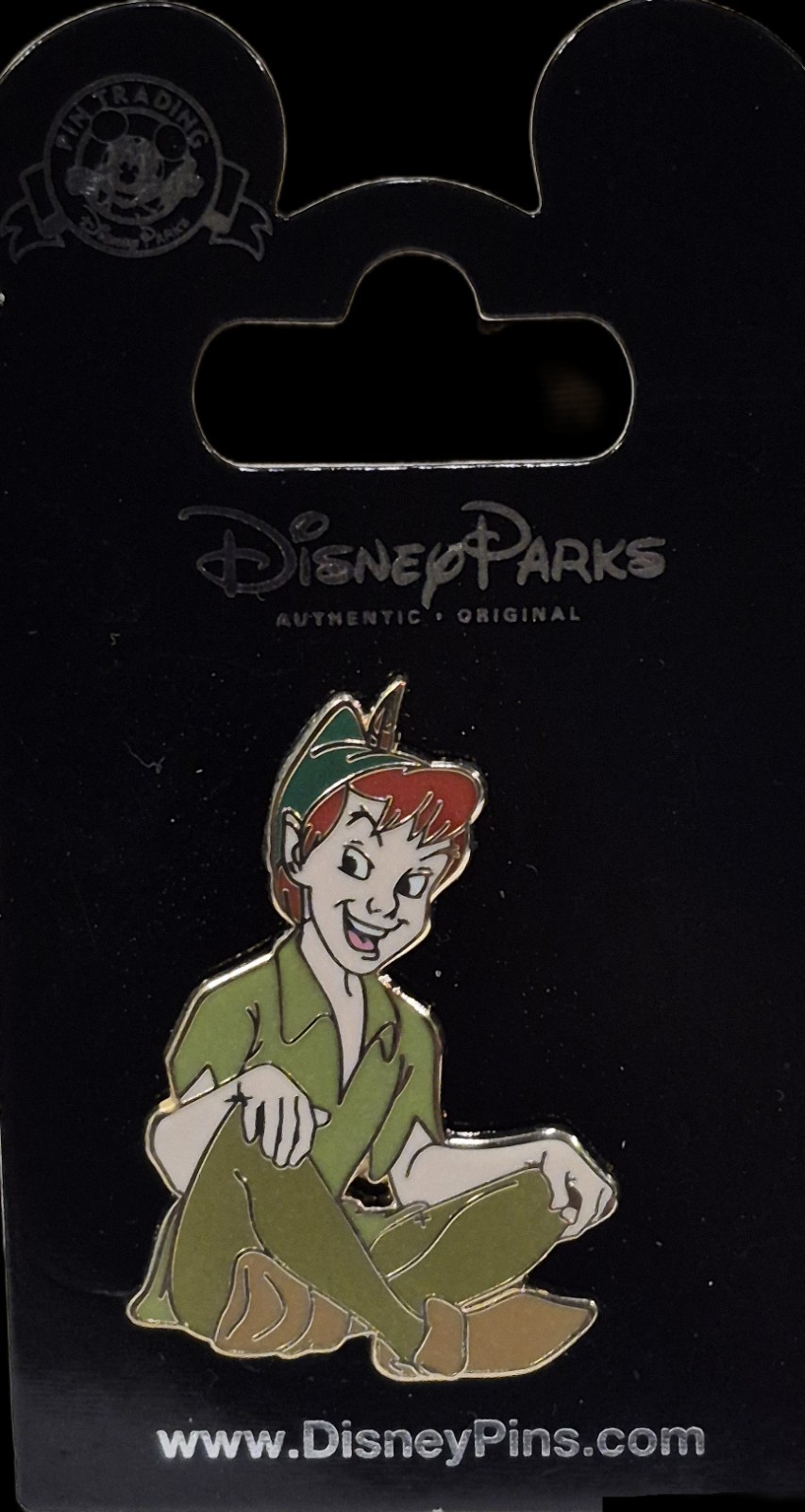 Disney Parks Trading Pin featuring Peter Pan In Crosded Legs Sitting Position 