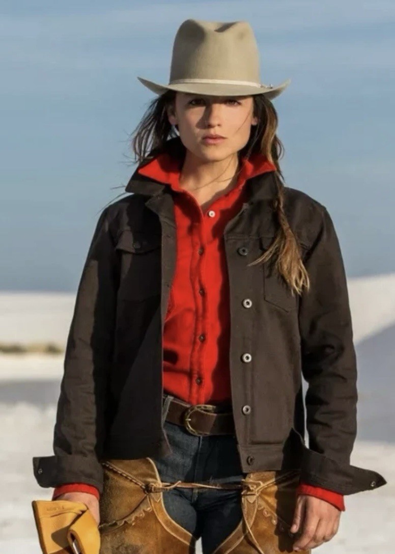 Brown canvas FILSON women’s jacket with red collar, front buttons, and tan leather belt loops.