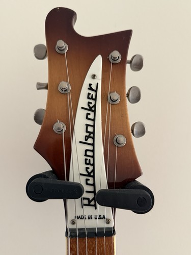 Brown and cream 1981 Rickenbacker 480 with white inlay, silver hardware, and “Made in U.S.A.” text on head.