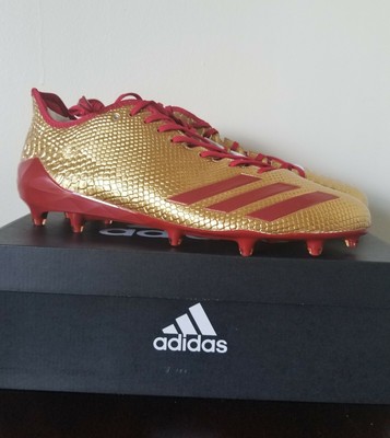 red and gold adidas football cleats