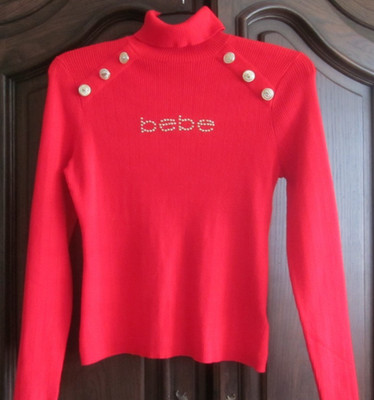 BEBE Red turtleneck Sweater Has ''bebe'' in gold dots and Gold Buttons on Shoulder