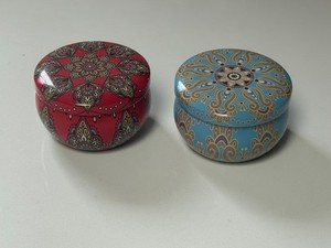 2 ornate red and blue Metal candle holders with intricate designs