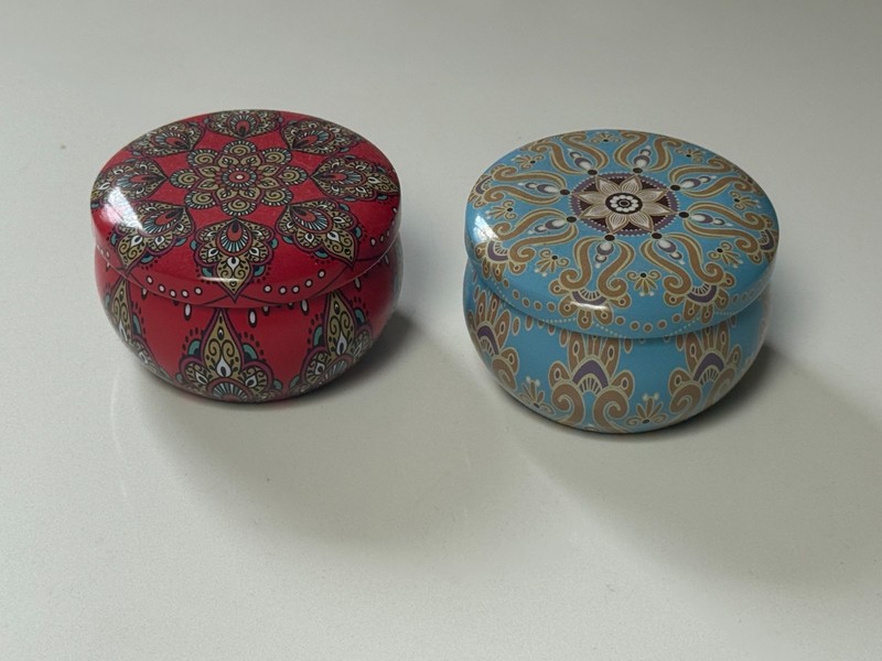 2 ornate red and blue Metal candle holders with intricate designs