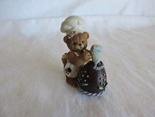 Bear Chef Decorating a Chocolate Easter Egg with Bear Paw on Apron