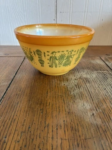 Glossy orange Pyrex Butterprint bowl pictured details on bottom of bowl