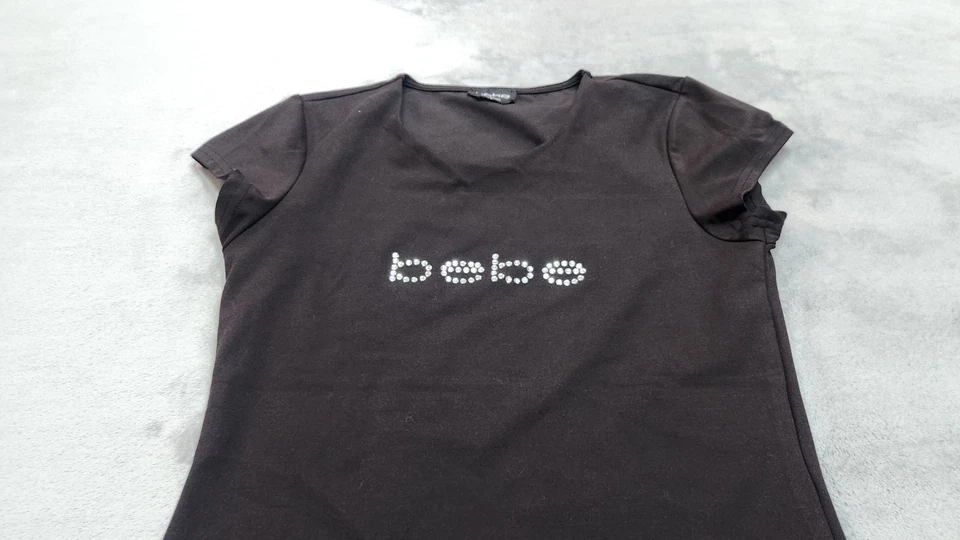 Blusa BEBE Para Mujer Pequeña Estrás Negra Cuello Abierto Corte Frontal Top Camisa Foto 2 de 4