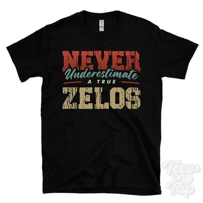 NEVER UNDERSCHIMATE A TRUE ZELOS T-SHIRT - Wear Your Name Proudly