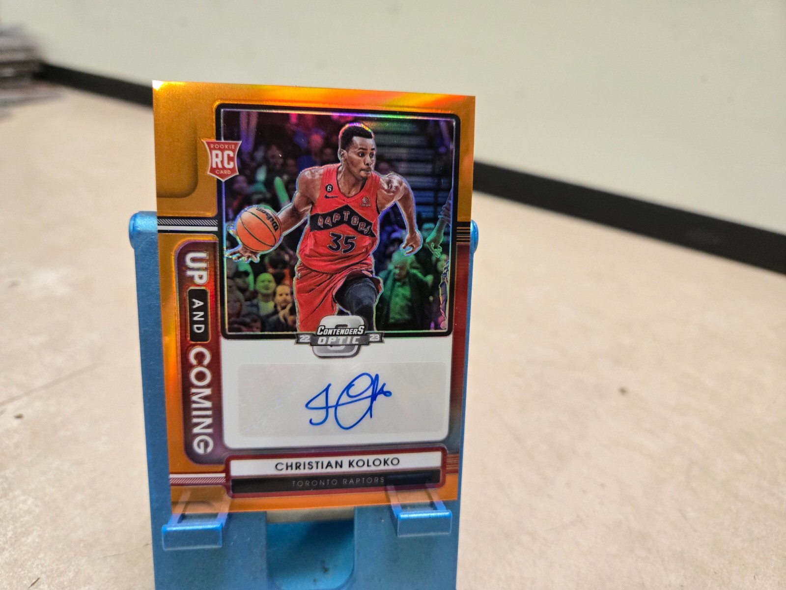2022-23 Contenders Optic Christian Koloko Up & Coming Auto Orange 25/25 RC