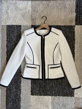 Calvin Klein Women  s White blazer with black Detailin and a zip-up front. Size 4