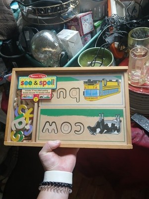 Melissa & Doug See & Spell learning toy features 8 double-sided wooden boards