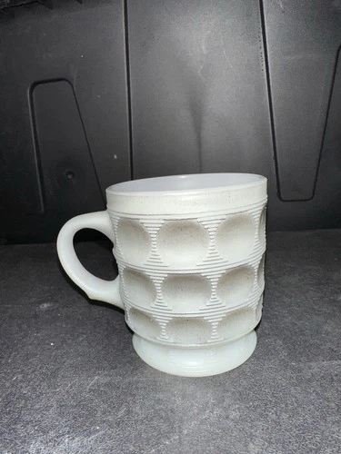 This is a vintage Fire-King Camelot Thumbprint mug made by Anchor Hocking