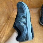 Black and gray New Balance 1540V2 men’s running shoe with mesh upper, suede overlays, and large “N” logo on side.