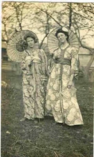 pc13724 postcard  Two women in fancy dress garment with parasoles