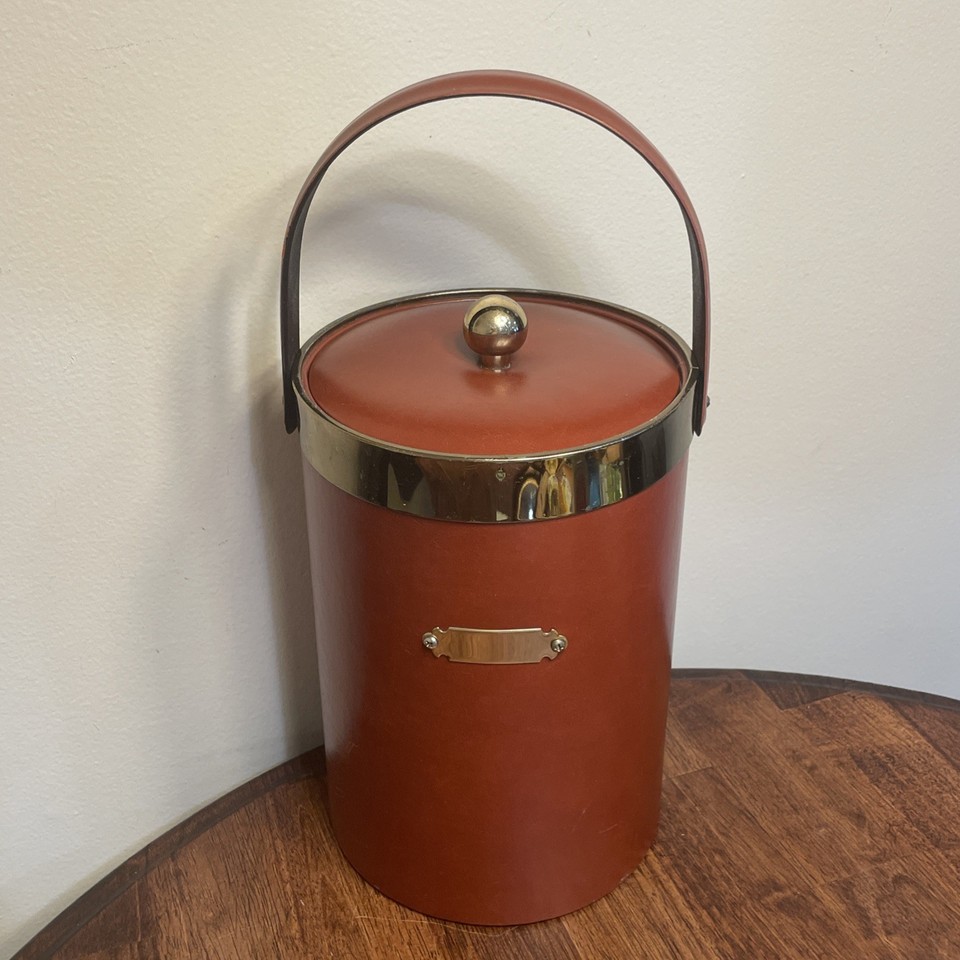Georges Briard was THE name in MCM barware — this red vinyl and brass ice bucket is a signed, collectible piece of American design history.