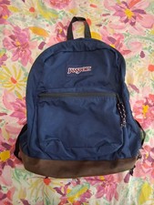 JanSport Classic backpack in navy blue with a signature suede leather bottom