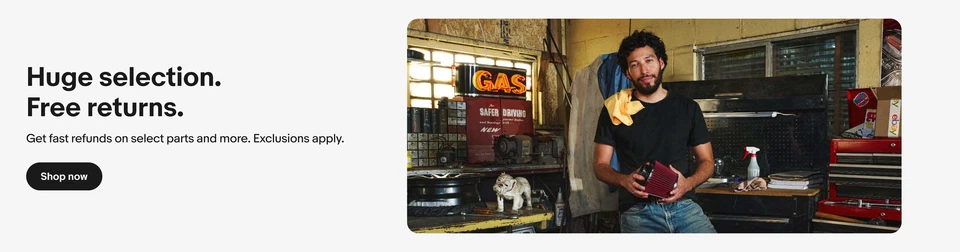 An image of a man standing in a garage holding an air filter, against a white background.