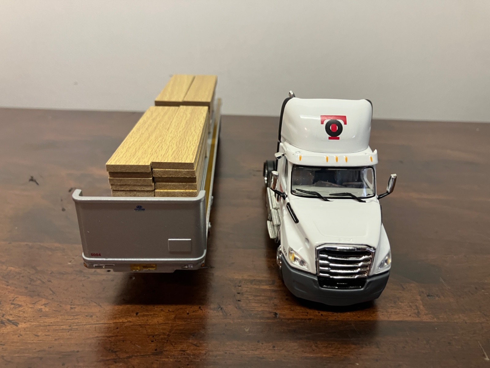 DCP First Gear 1/64th Osterkamp Trucking Cascadia Day Cab and 45' Flatbed w/load