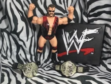 1998 wcw scott hall vintage action figure with 2 belts and a wwf sign