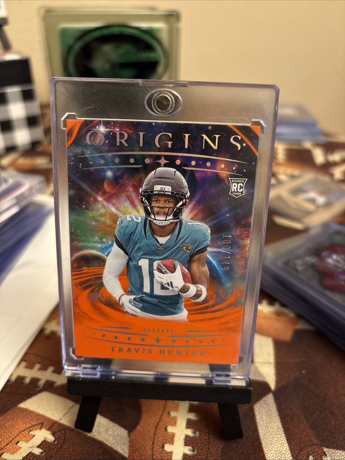 2025 Panini Origins - Rookies Travis Hunter, Travis Hunter #142 Orange /149 (RC)