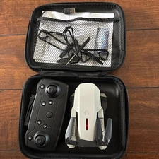 Foldable white drone with 2 batteries, 1 controller, 4 extra propellers, charger