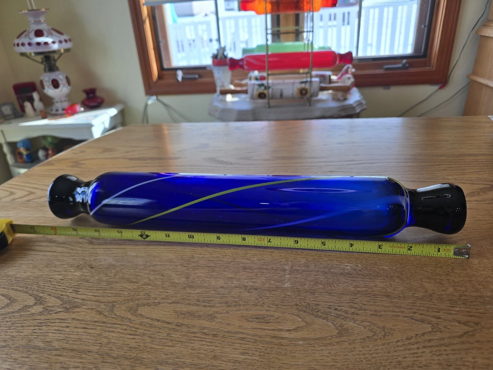 The image shows a vintage cobalt blue art glass rolling pin.