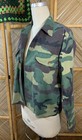 USA-made vintage camouflage ranger shirt with green forest pattern, button front, and two flap chest pockets on mannequin.