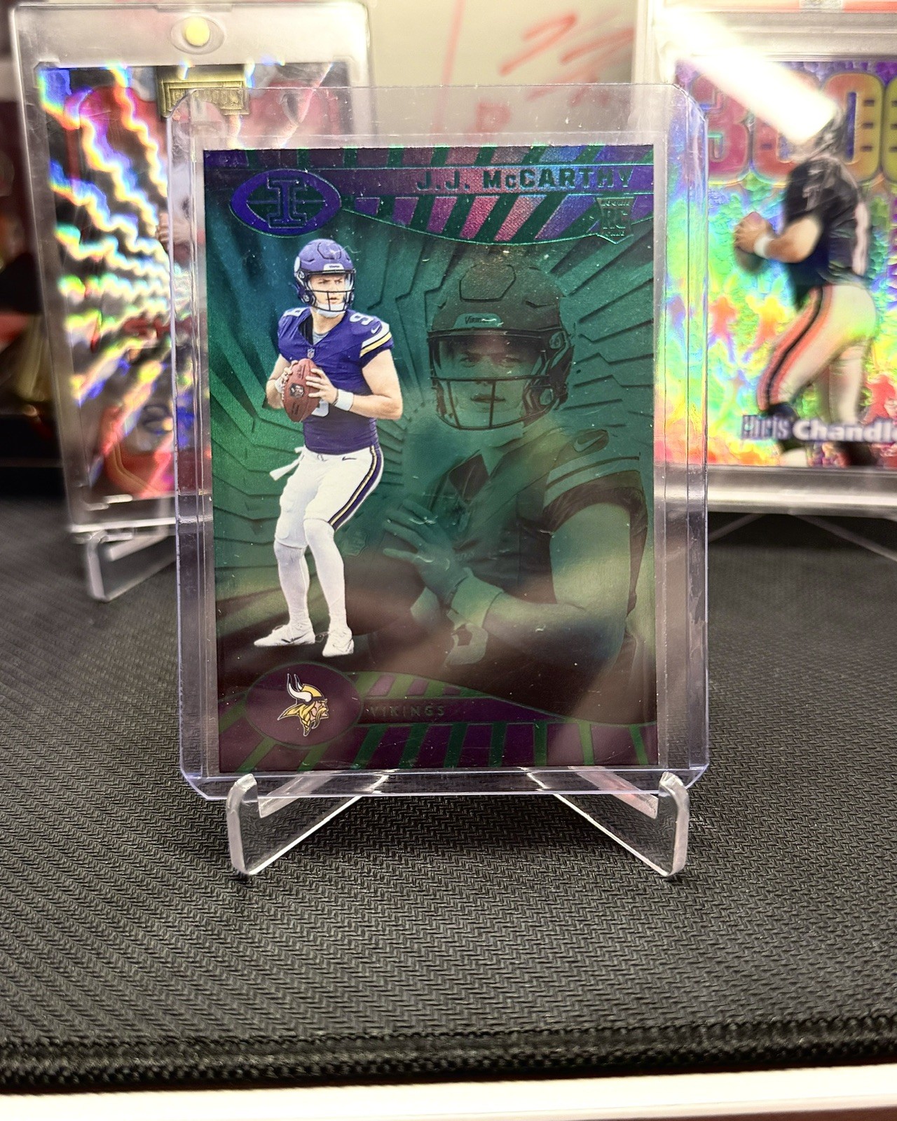 2024 Panini Illusions #100 JJ McCarthy Rookie Emerald Trophy Collection