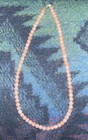 s….Vintage Beaded 17” Necklace Coral/Pink Colored With A Cross At The Closure