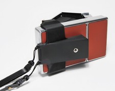 POLAROID ADATTATORE X TREPPIEDE X SX 70 + CINGHIA CON ATTACCO RAPIDO.