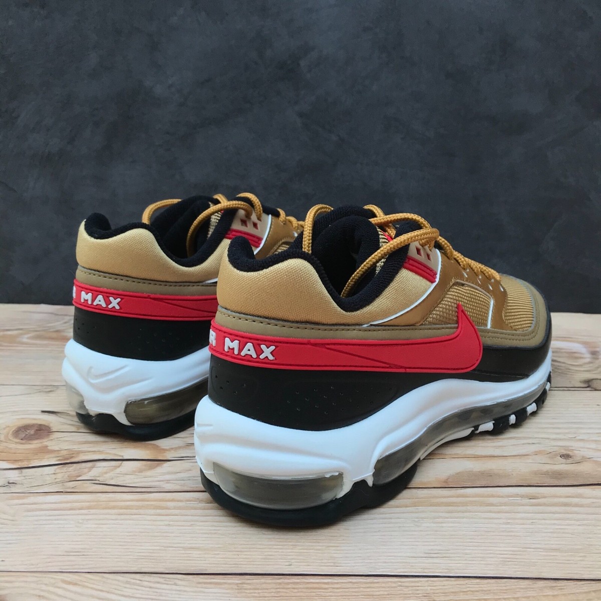 gold black and red air max 97