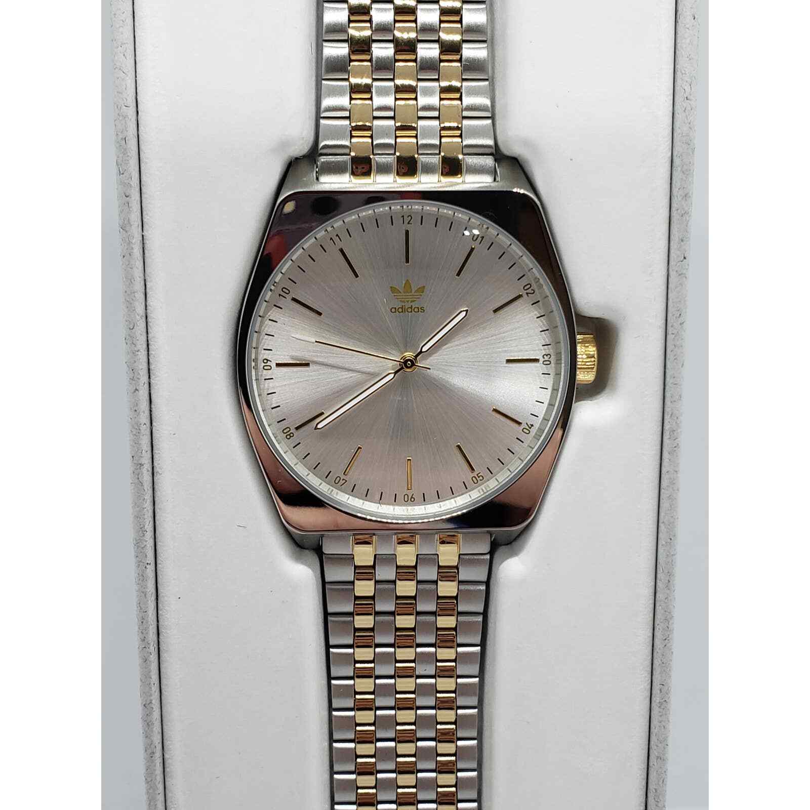 Adidas by Nixon men's watch. Silver face with gold accents Z021921-00 New In box