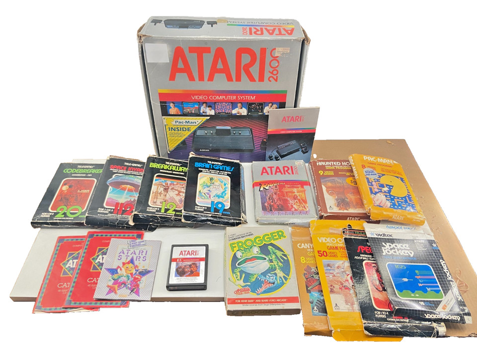 A complete boxed Atari 2600 lot with original boxes and manuals — this is a time capsule of 1970s gaming history, not just a console.