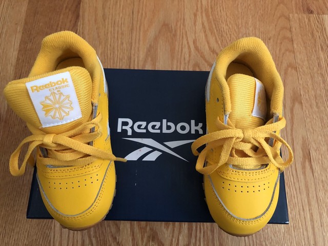 black and yellow reebok classics