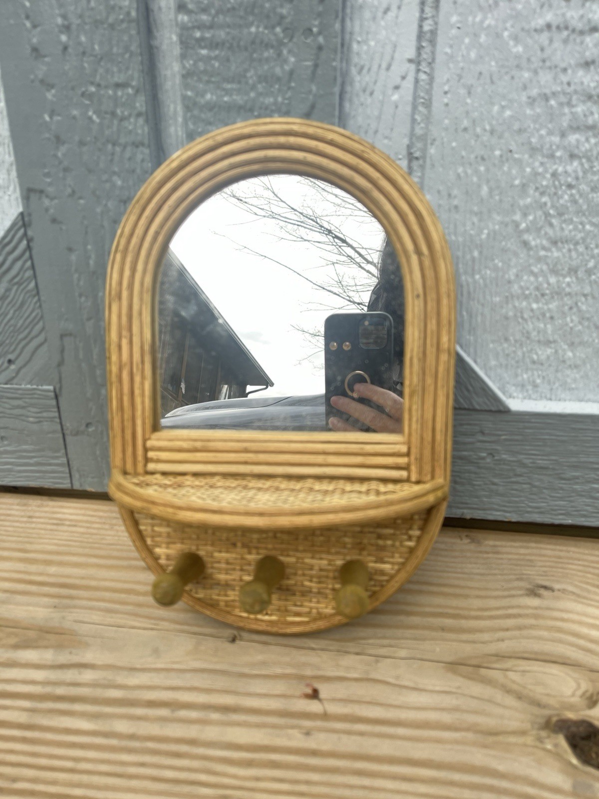 Rattan or wicker wall mirror with attached hooks