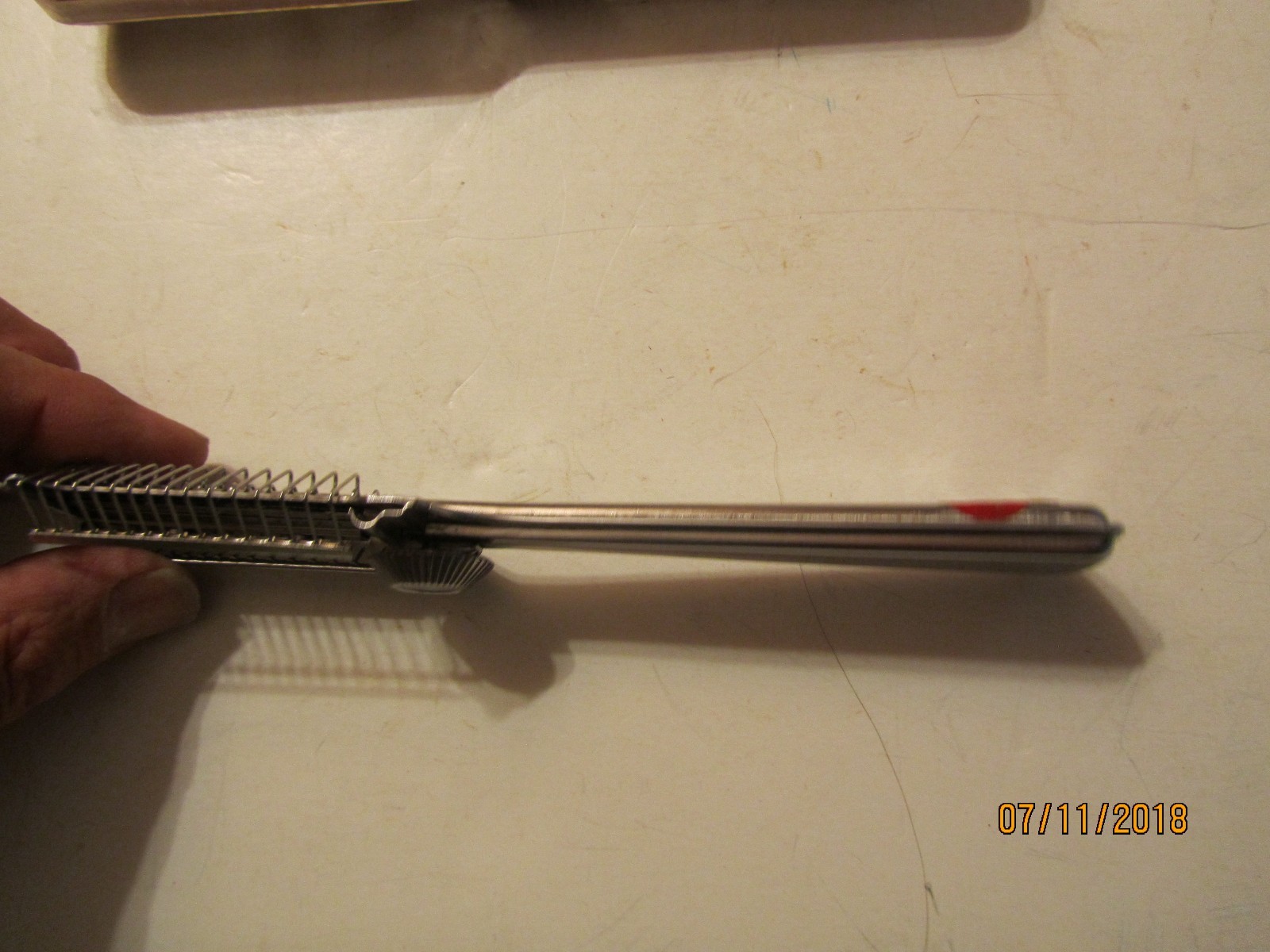 Silver vintage Playtex hair cutter with black handle, gold accents, and “Made in U.S.A.” text on side handle.