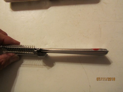 Silver vintage Playtex hair cutter with black handle, gold accents, and “Made in U.S.A.” text on side handle.