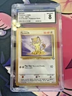 1999 Pokémon Jungle Meowth Gold Border Pokémon Rolls 56/64 CGC 8 NM/MINT