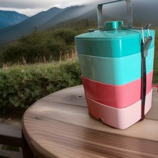 A Jhon Lewis 4 Tiered Handle Picnic Tiffin multi coloured Box with Secure Strap.