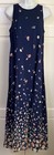 Navy blue midi dress with small white floral print, pink edges, sleeveless design, and “E.D. Michaels” label on neckline.