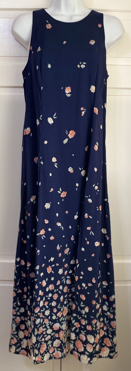 Navy blue midi dress with small white floral print, pink edges, sleeveless design, and “E.D. Michaels” label on neckline.