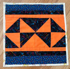 Quilted table topper , new handmade, 13x 13 patched orange and dark blue