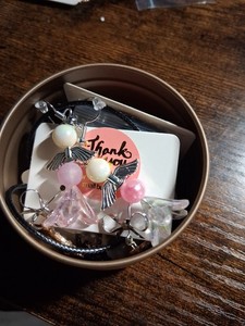 A Mystery Jewelry Tin With Earrings And More Inside This Comes A Purple Bow .