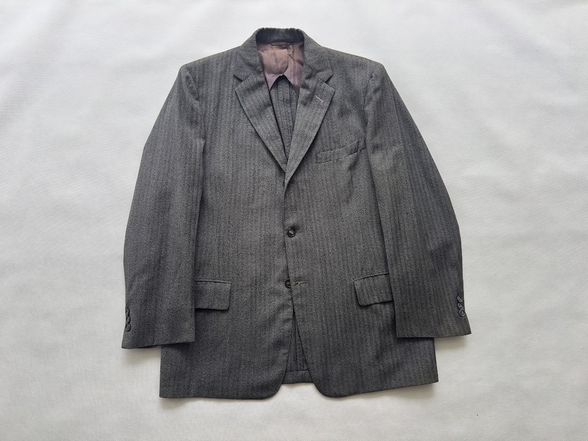 Grey pinstripe wool suit jacket, laid flat.