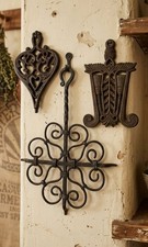 Offering a collection of vintage black, cast iron trivets