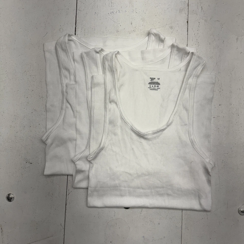 Paquete de 3 camisetas sin mangas Reebok blancas lisas acanaladas para hombre talla mediana Foto 2 de 4
