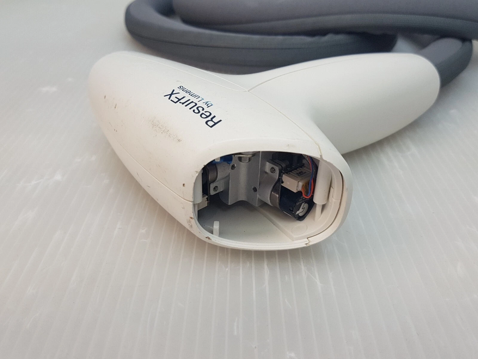 Open front end of the ResurFX handpiece showing internal parts
