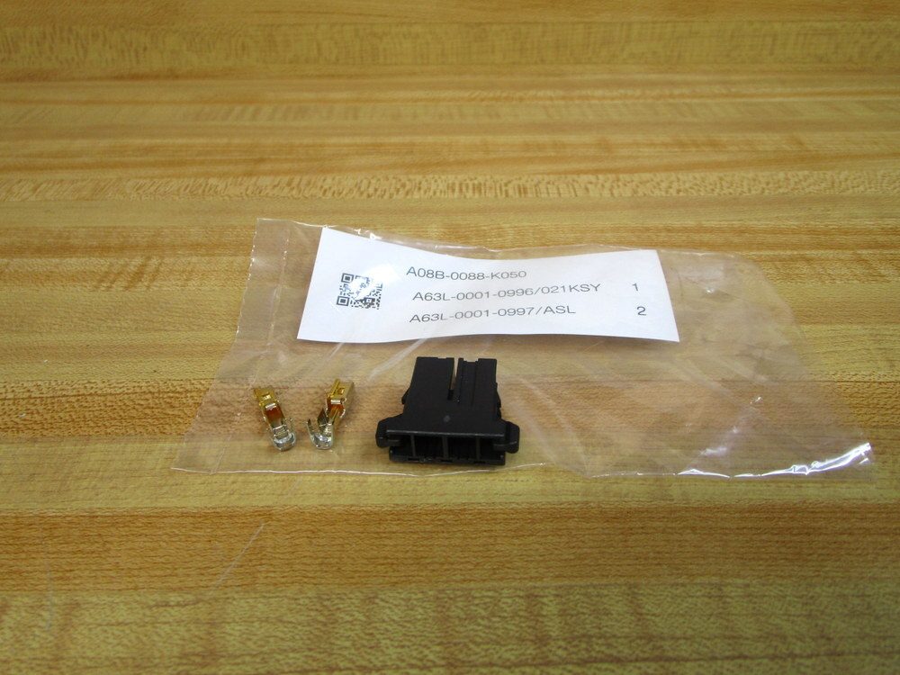 Clear plastic bag with black connector, two gold pins, label “A08B-0088-K050” and “A63L-0001-0996/021KSY” on wood surface.