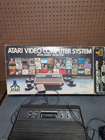 Atari 2600 Video Game Console With 2 Controllers,  Catalog & Damaged Box